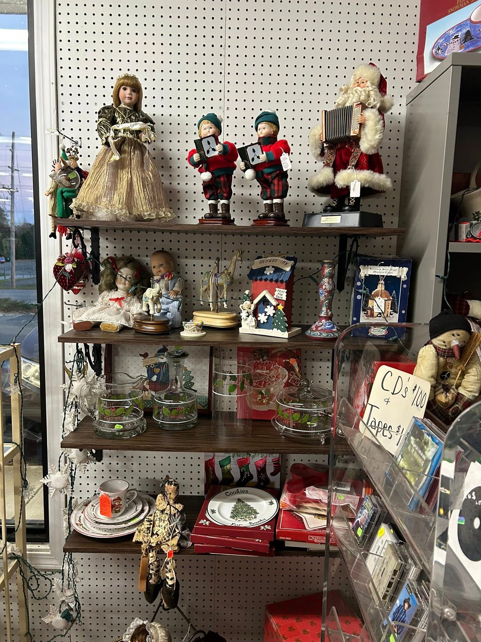 Holiday figurines and decorations displayed on shelves in a store aisle