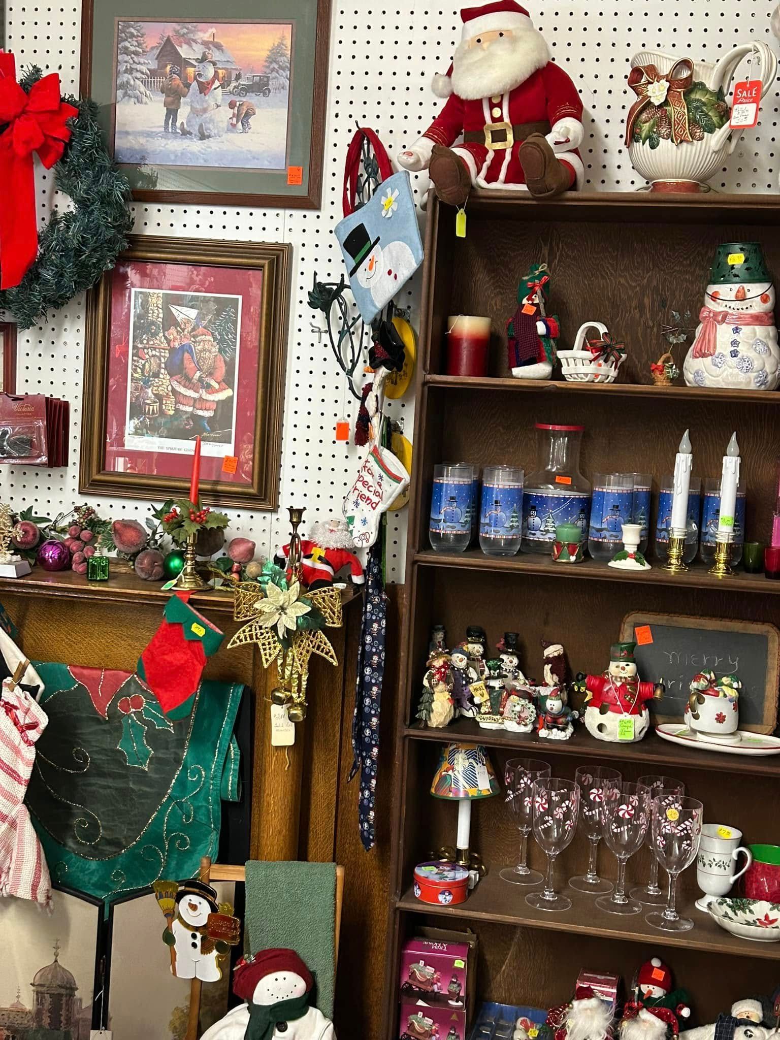 Halloween decorations and candy displays on store shelves, with jack-o'-lanterns and a witch hat.