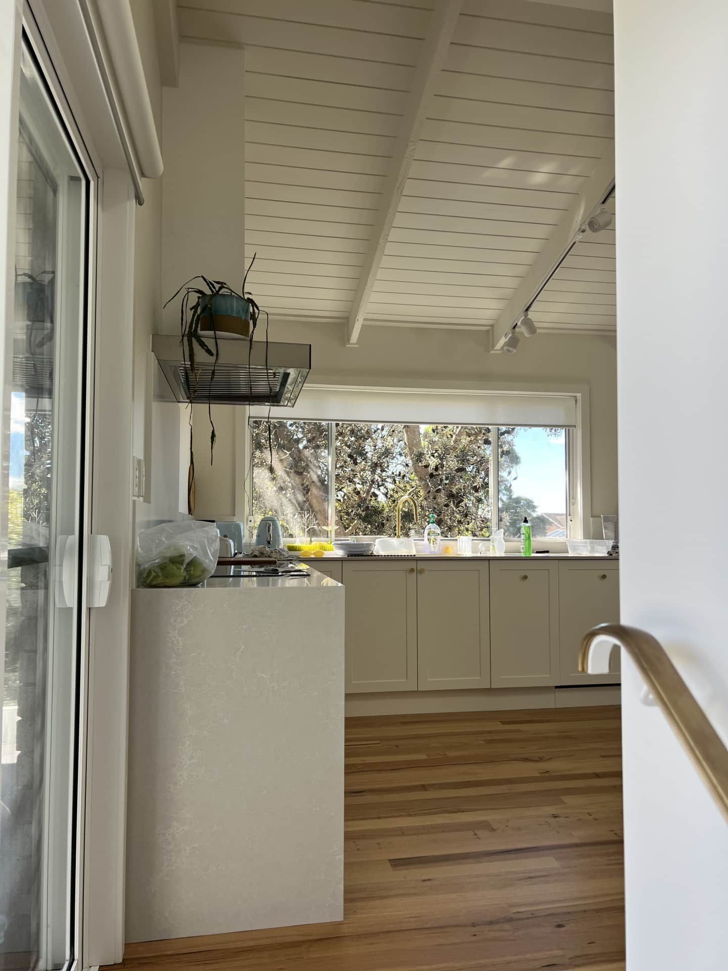 A Bright Kitchen With White Cabinets — Taddeo Constructions in Shellharbour, NSW