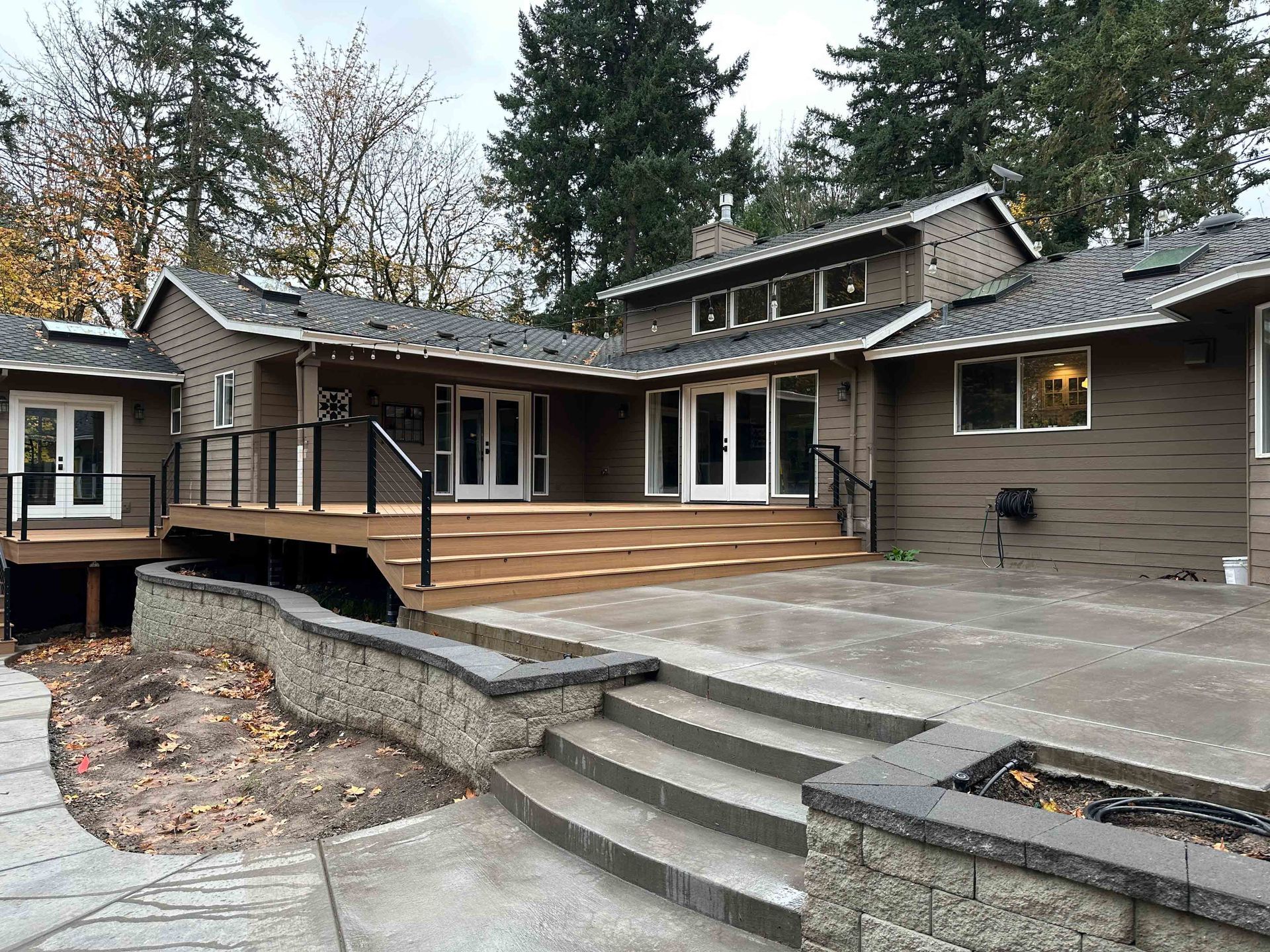 A house with concrete stairs and retaining wall.