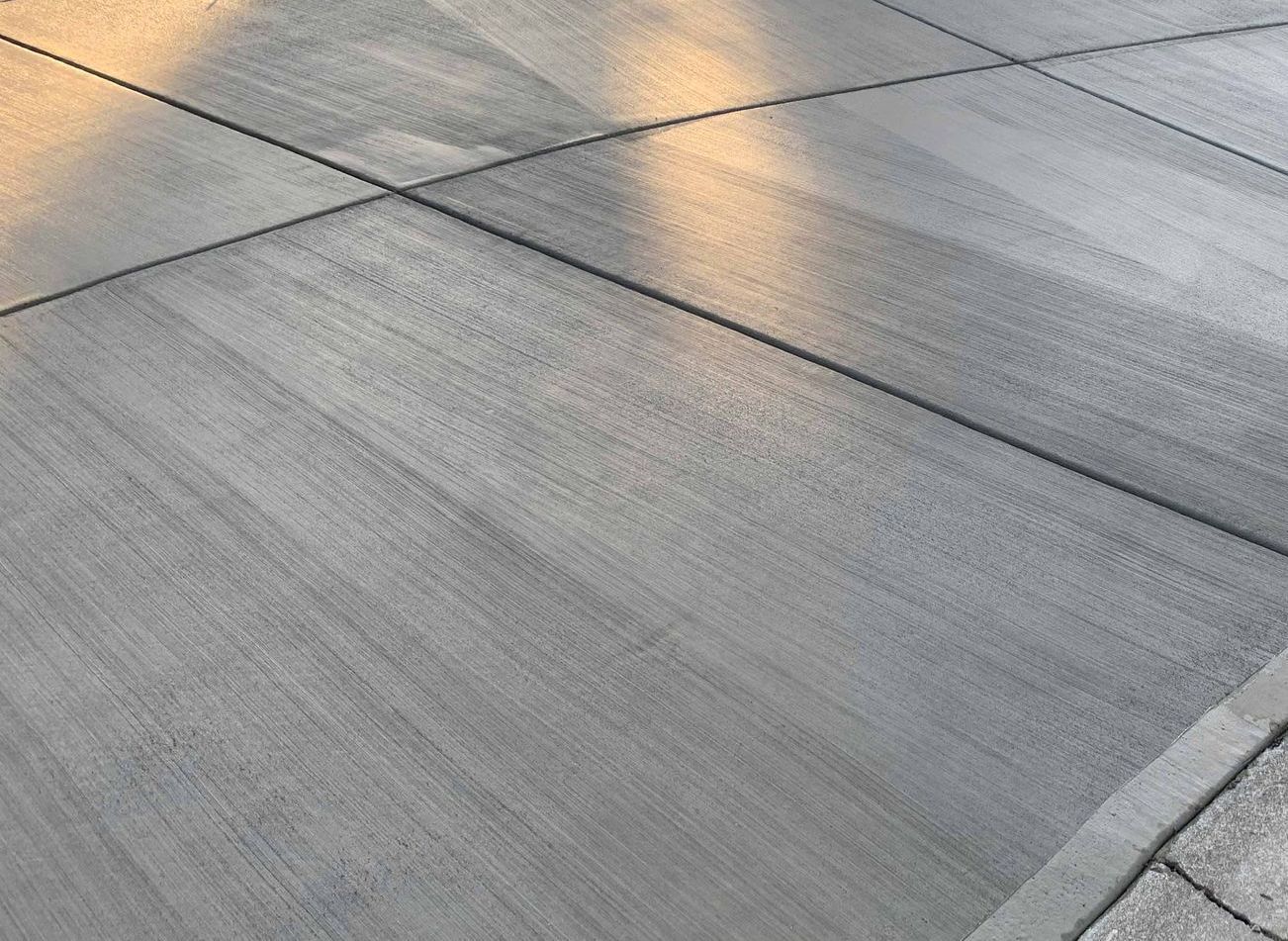 A close up of a concrete floor with a shadow on it.