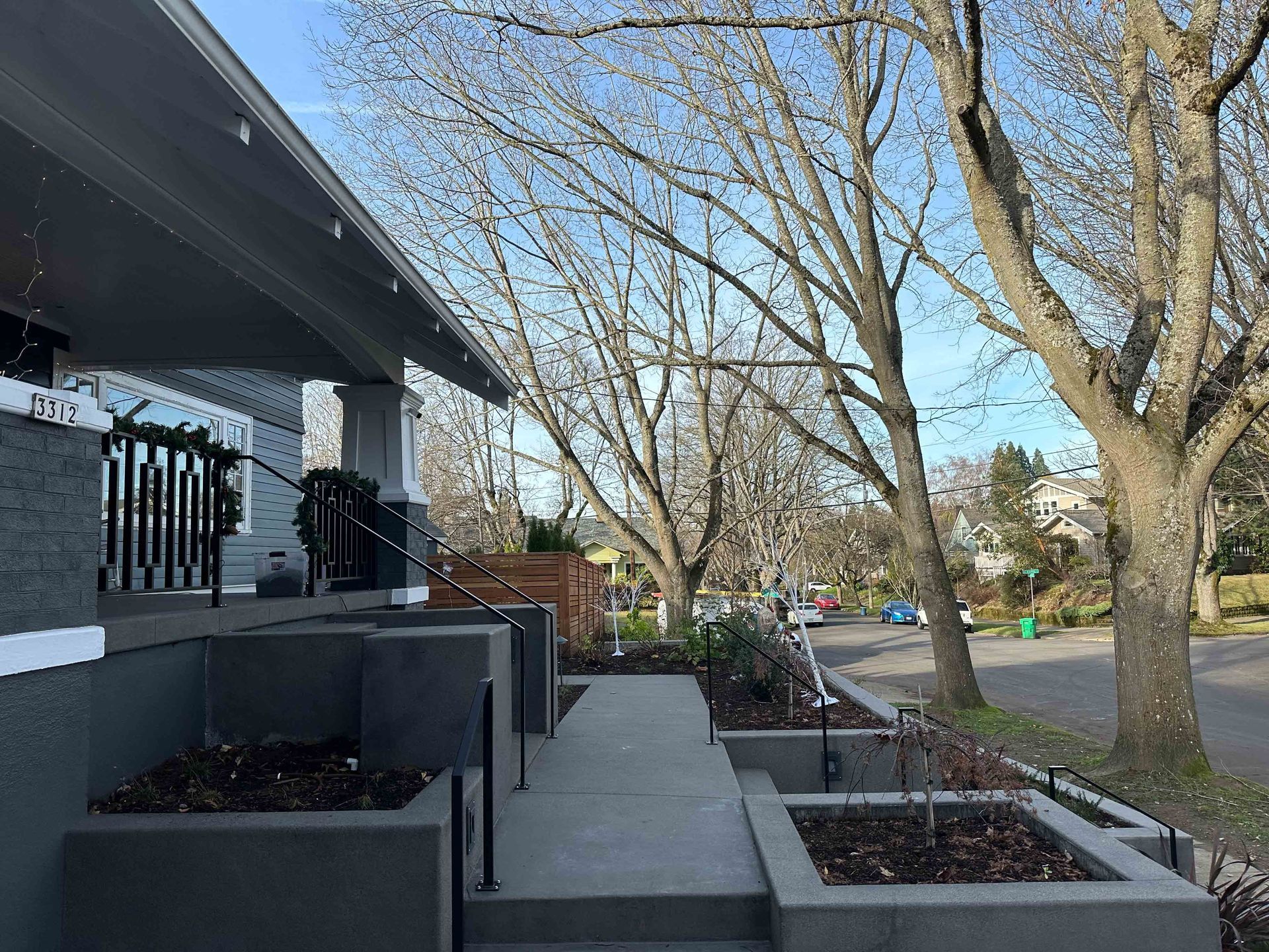 A house with concrete stairs and retaining wall.