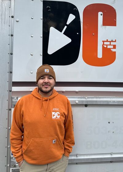 Jorge standing in front of Detailed Concrete sign in Portland OR