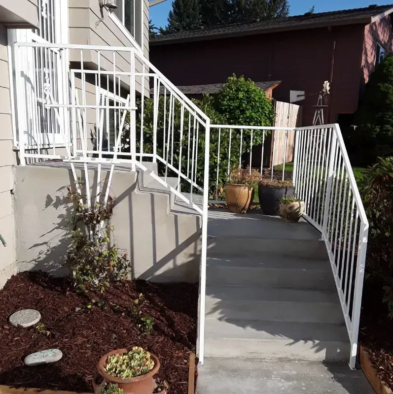A large house with a patio and stairs in front of it in Portland OR