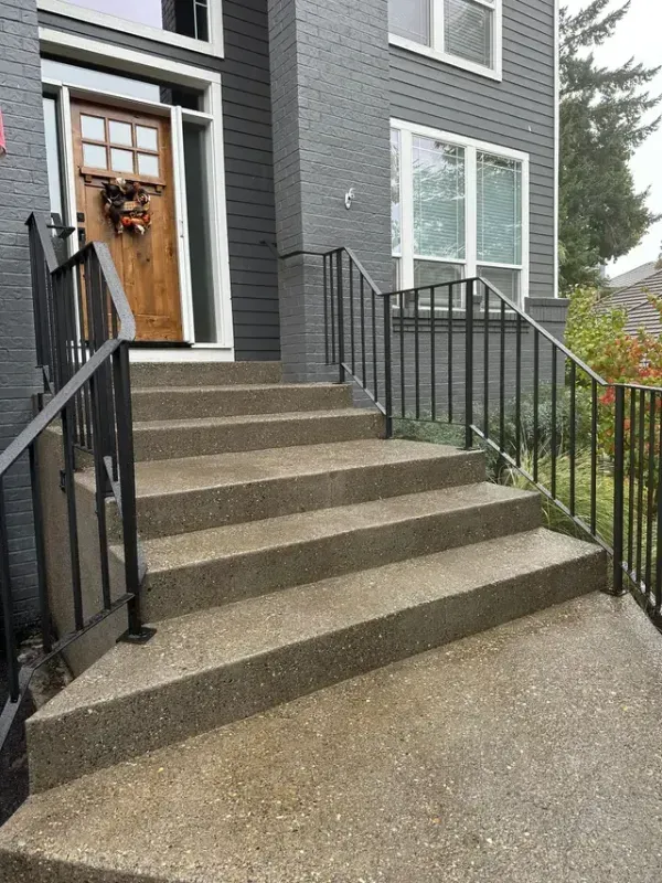 A large house with a patio and stairs in front of it in Portland OR