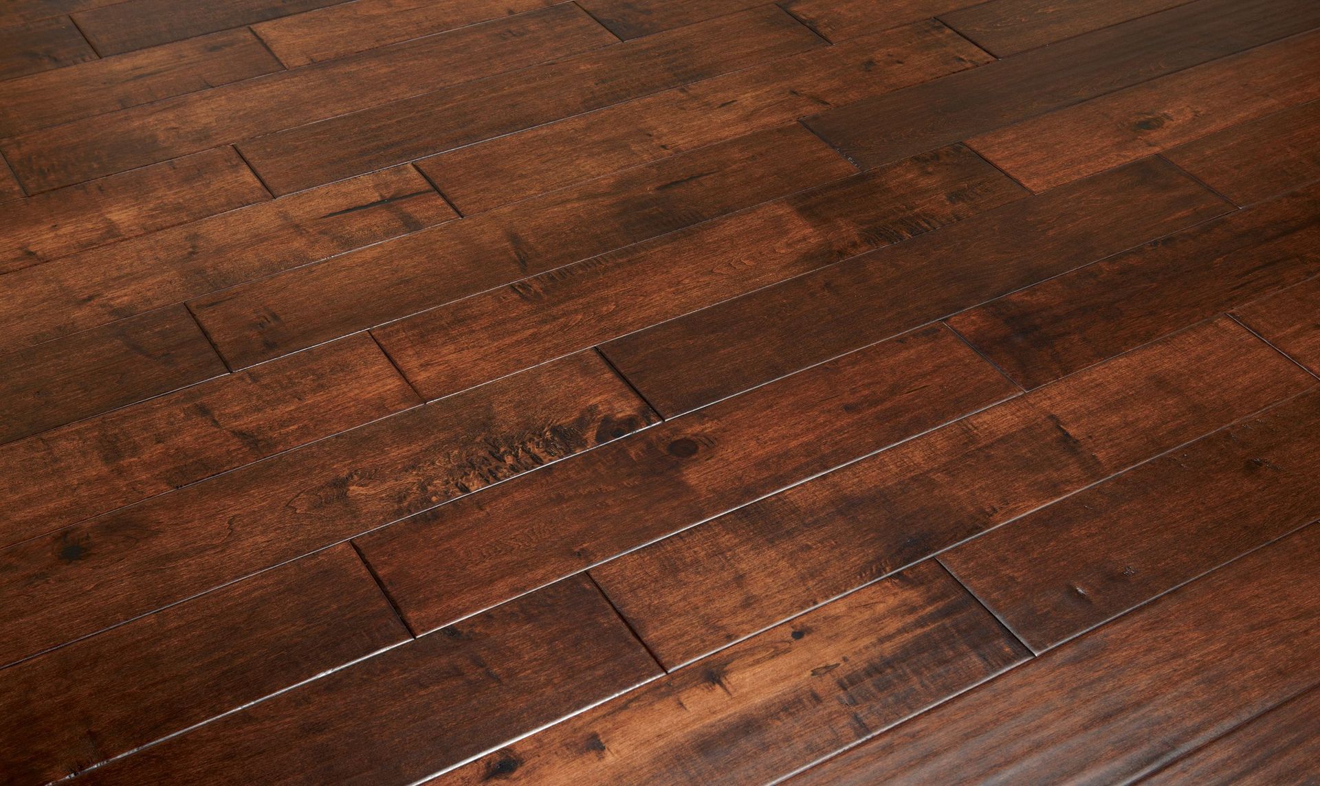 Dark brown hardwood flooring with visible wood grain and variations in color.