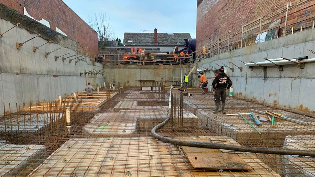A group of construction workers are working on a construction site.