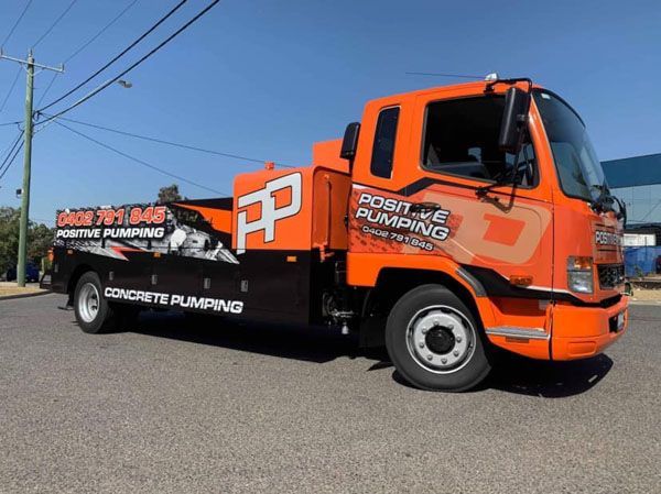 An orange truck with the word plumbing on it