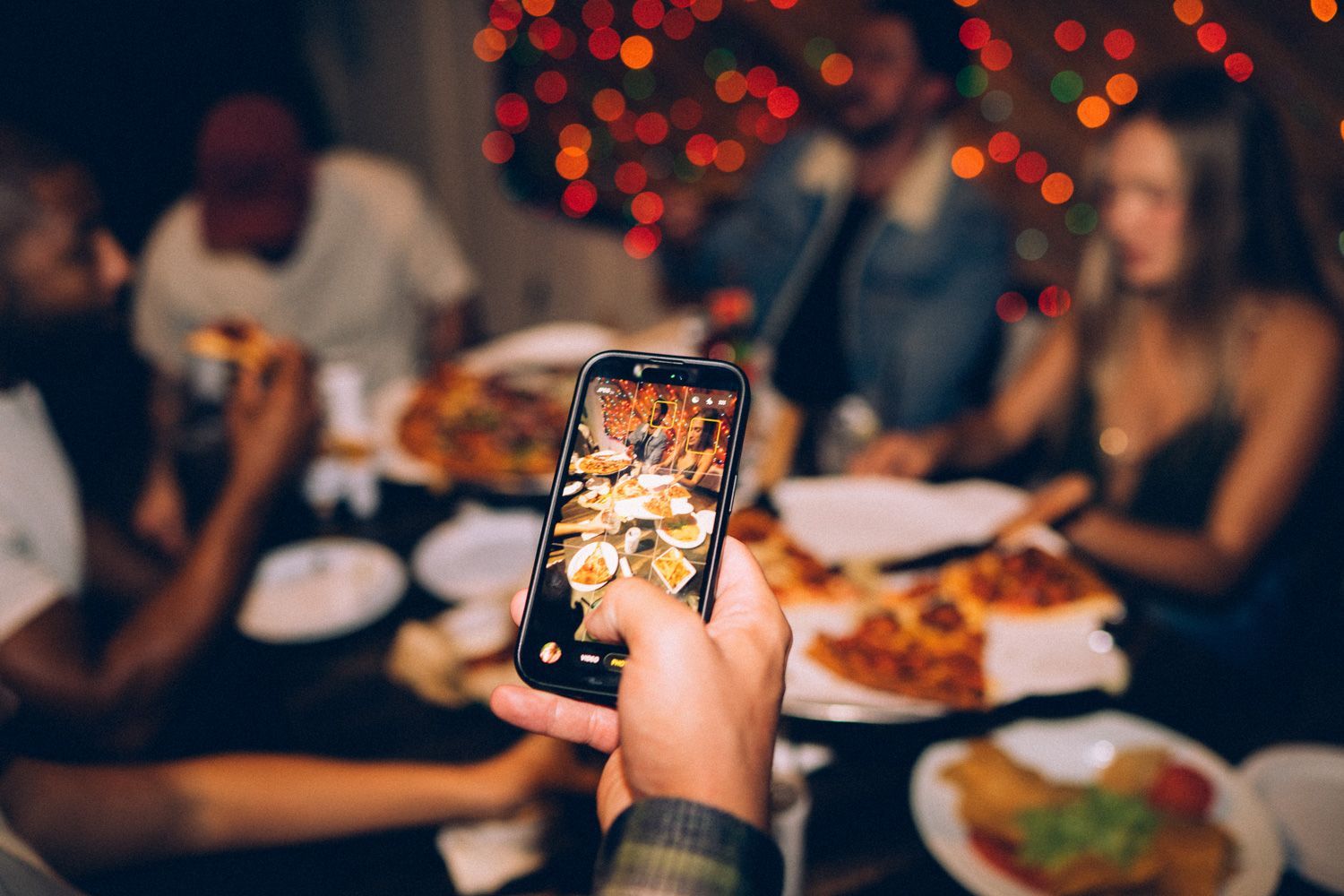 A guest photographing a table experience at Sugarshack Downtown