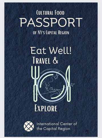 Cultural food passport poster with navy background, plate and utensils, promoting “Eat Well, Travel & Explore.”