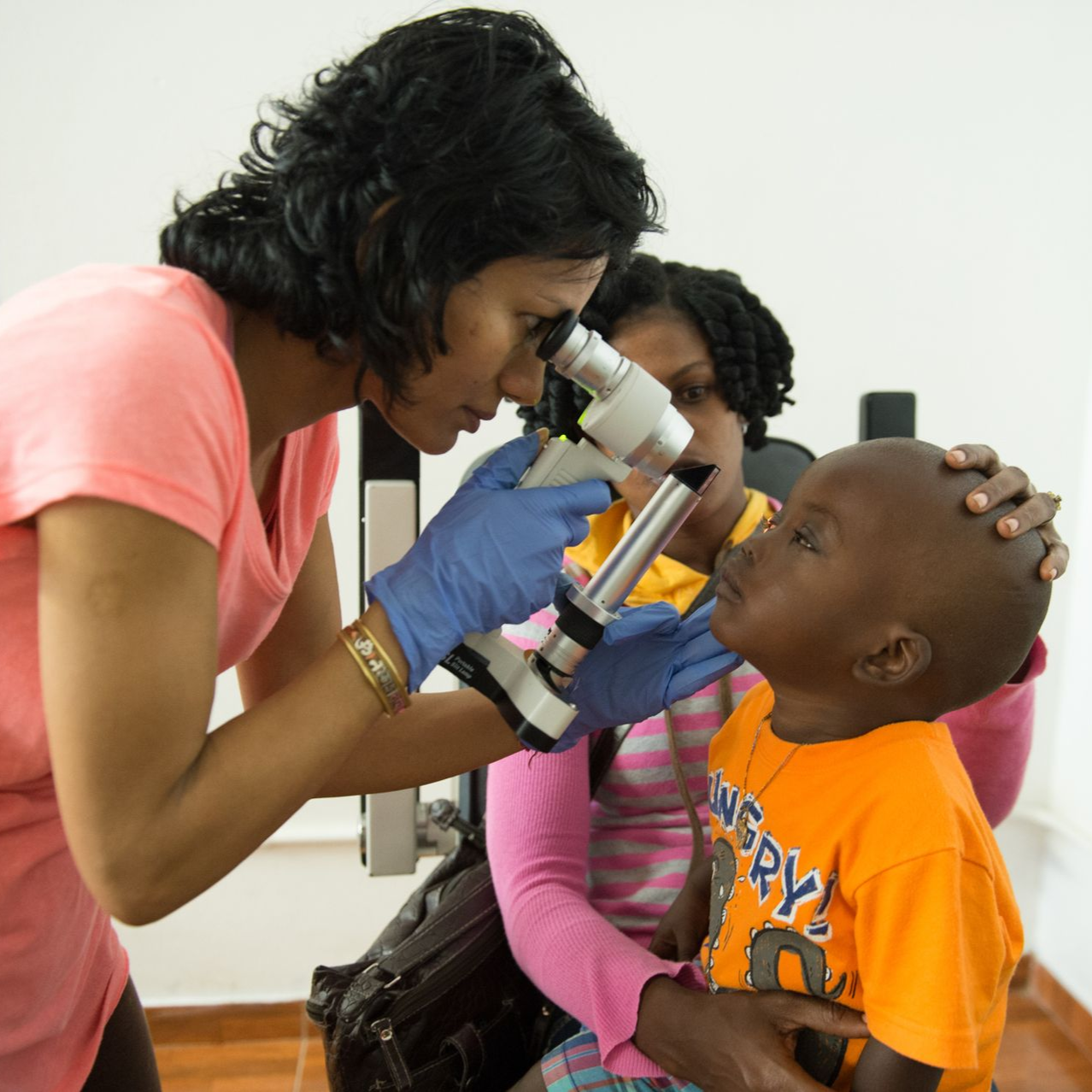 Eye exam with a handheld ophthalmoscope in a clinic