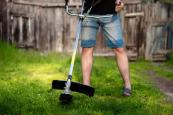 Man weed eating lawn in Cheyenne
