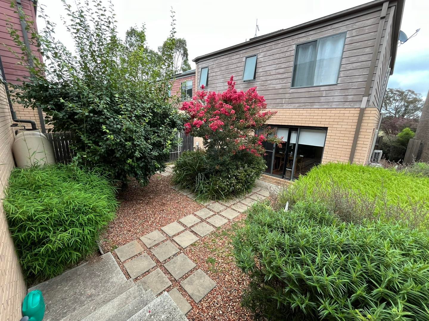 Before A Small Pond Surrounded By Rocks And Plants In A Garden — Canberra Home and Garden Maintenance in Tuggeranong ACT