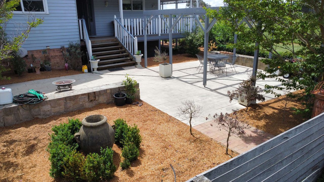 After A Dirt Path Leading To A House Surrounded By Trees And Bushes — Canberra Home and Garden Maintenance in Tuggeranong ACT