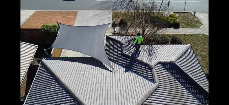 Man Standing on Roof Gutter Cleaning — Canberra Home and Garden Maintenance in Gordon, ACT