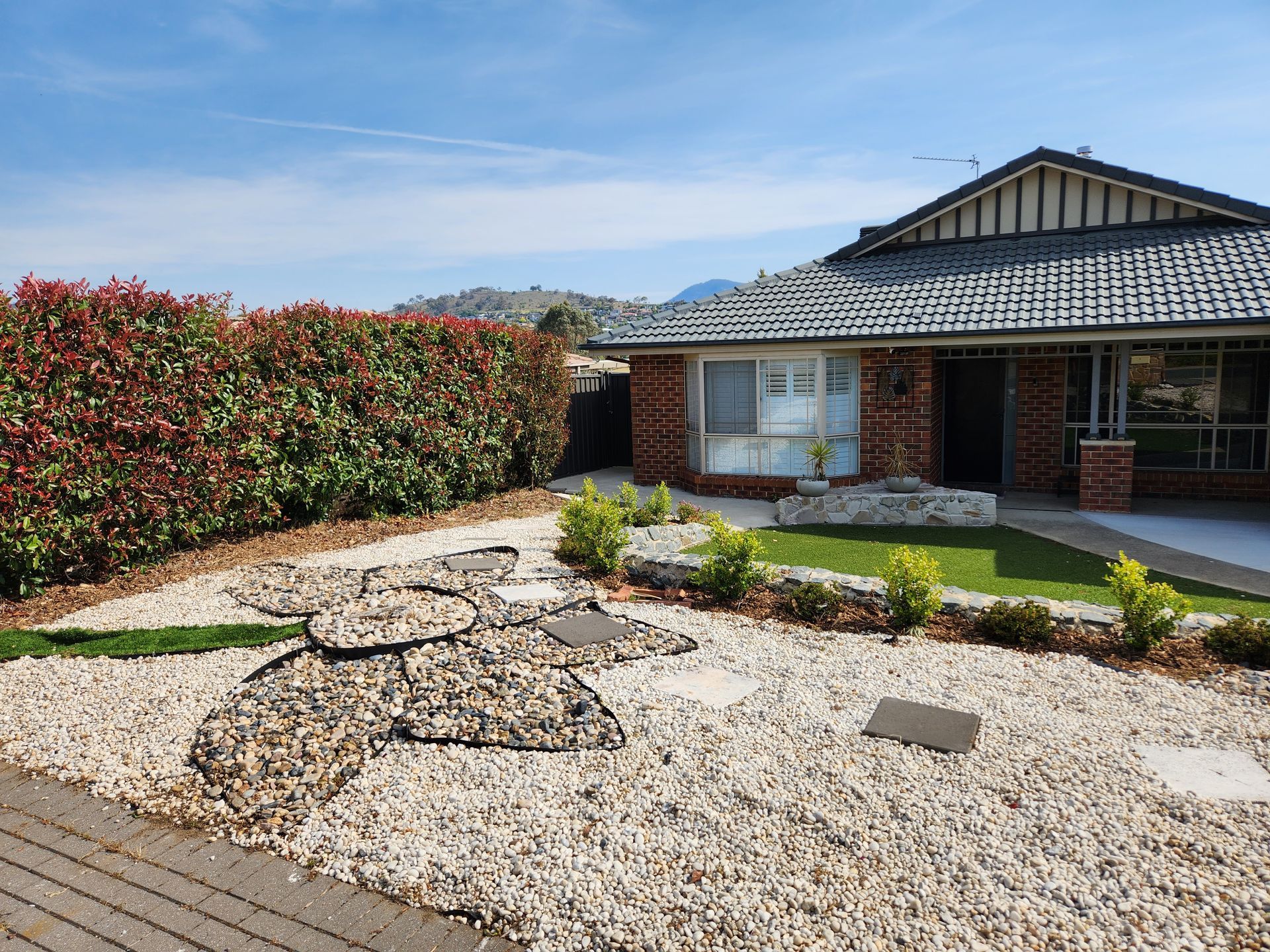 After A Wooden Deck With Chairs And A Table Overlooking A Body Of Water — Canberra Home and Garden Maintenance in Tuggeranong ACT