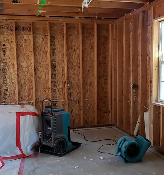 A room with wooden walls and a fan in it
