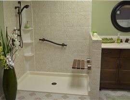 A bathroom with a walk in shower and a sink.