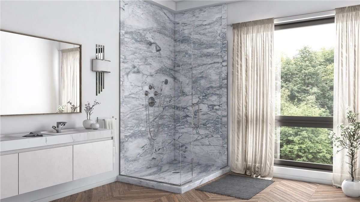 A bathroom with a walk in shower , sink , mirror and window.