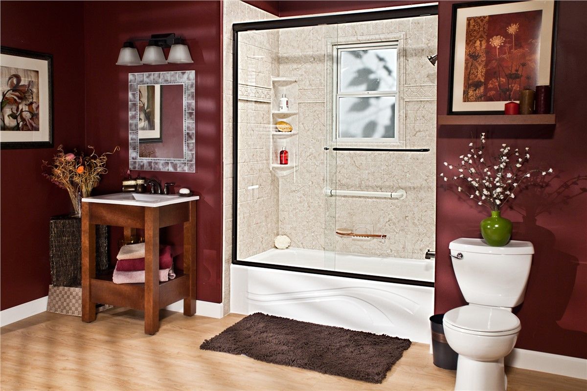 A bathroom with a tub , toilet , sink and mirror.