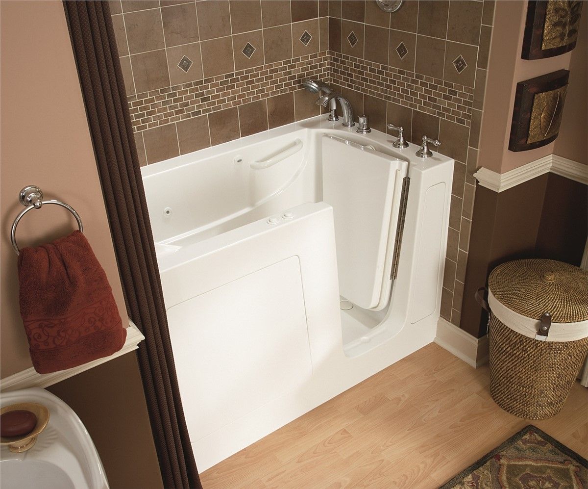 A bathroom with a walk in tub and a toilet