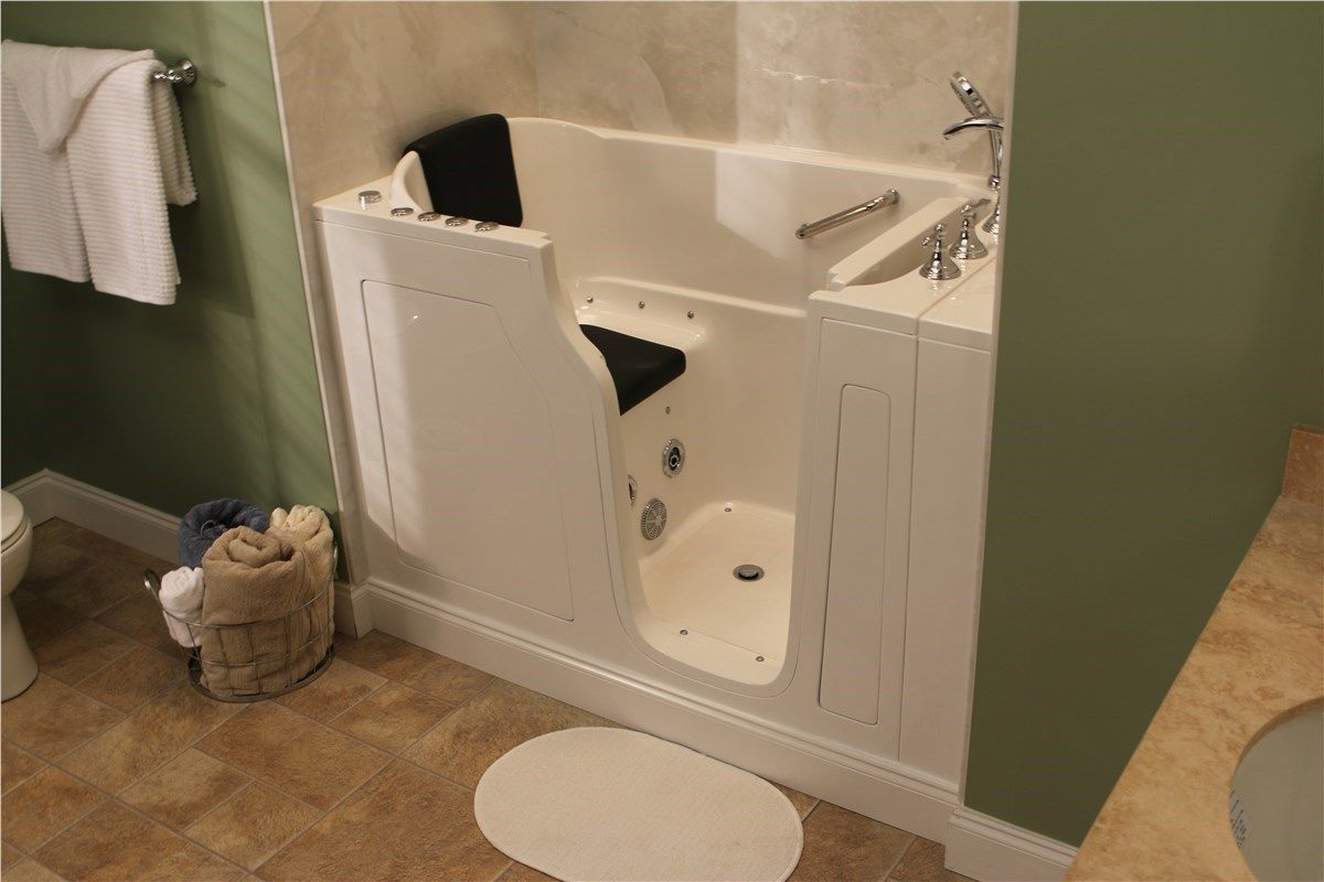 A bathroom with a walk in tub and a toilet.