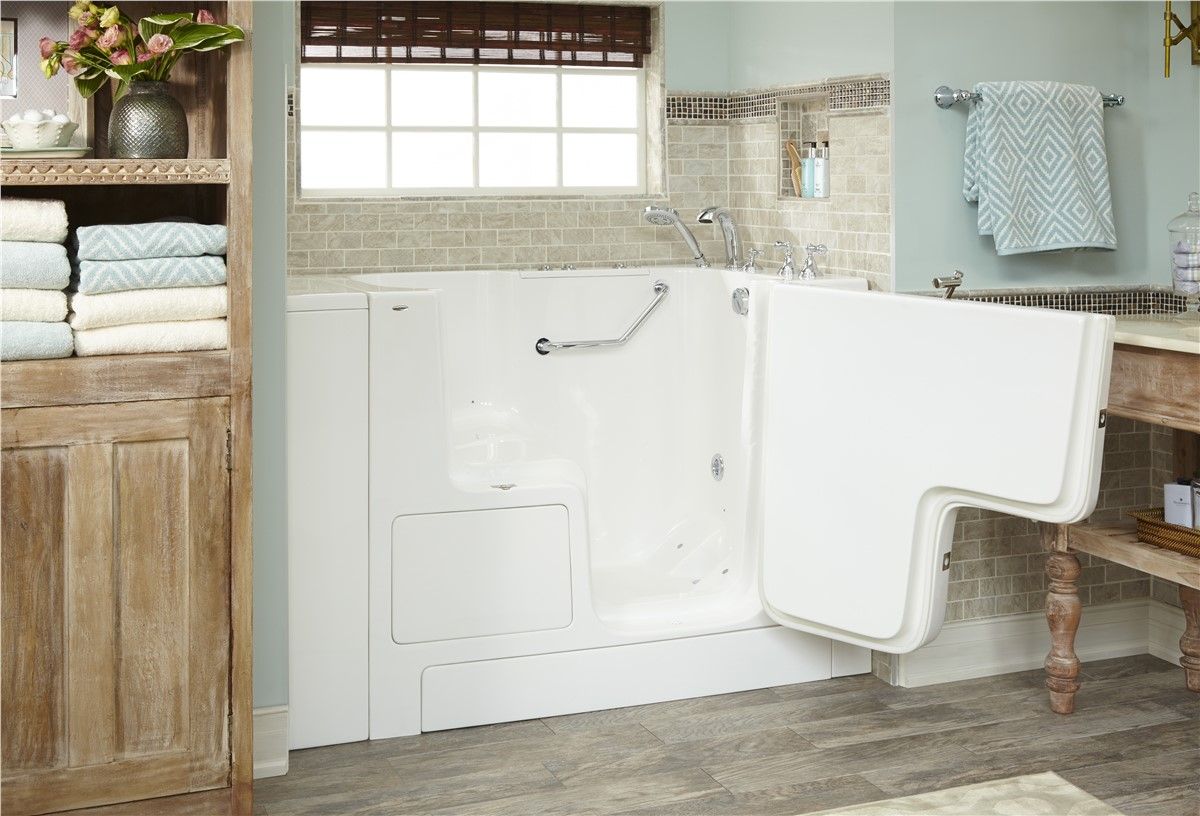 A bathroom with a walk in tub and a window.