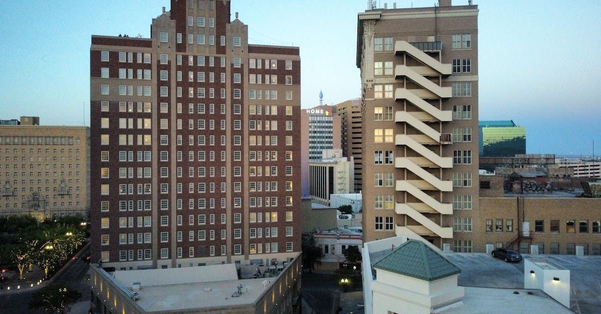 An aerial view of a city with a tall building in the foreground