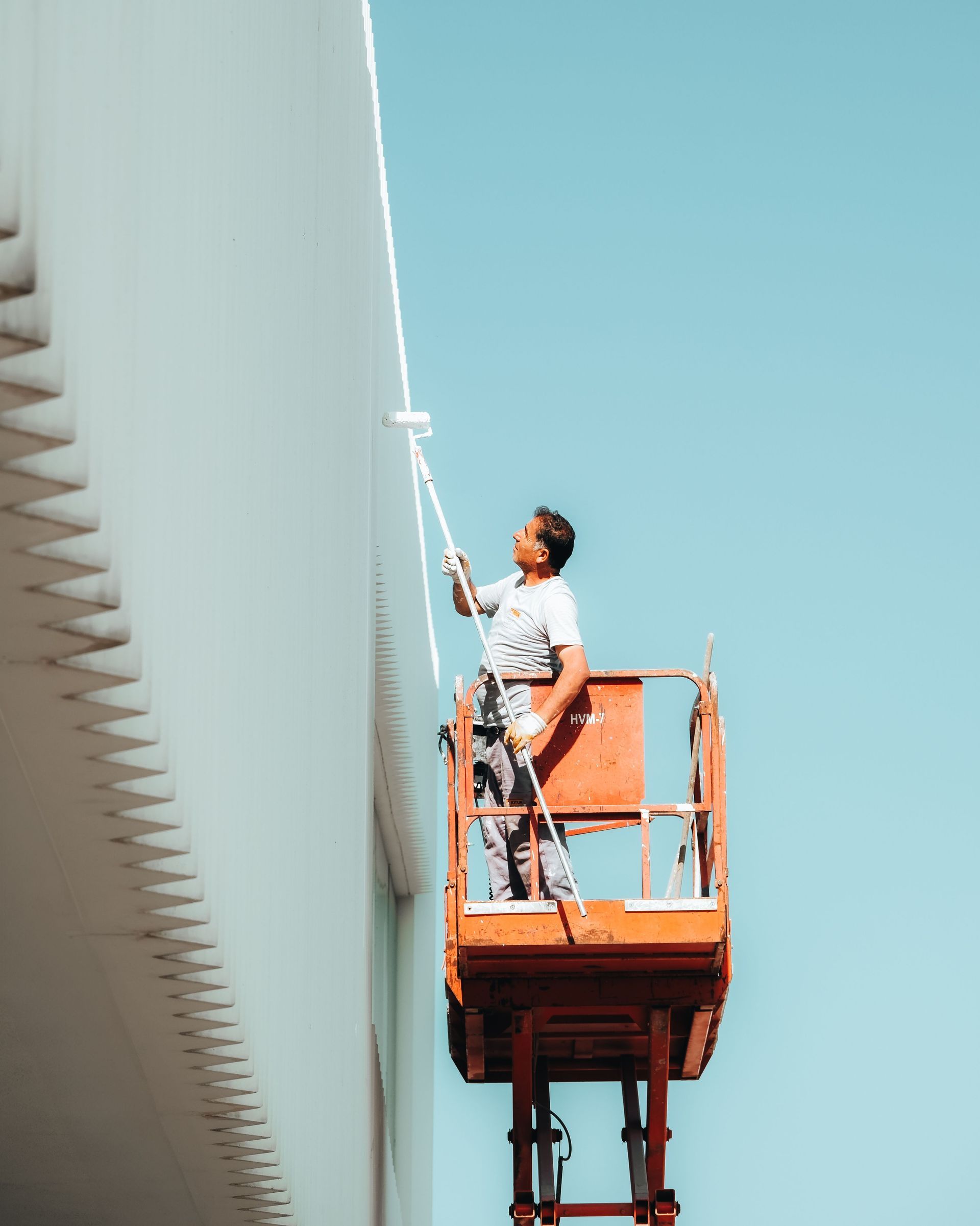 Painter rolling fresh paint onto an interior wall