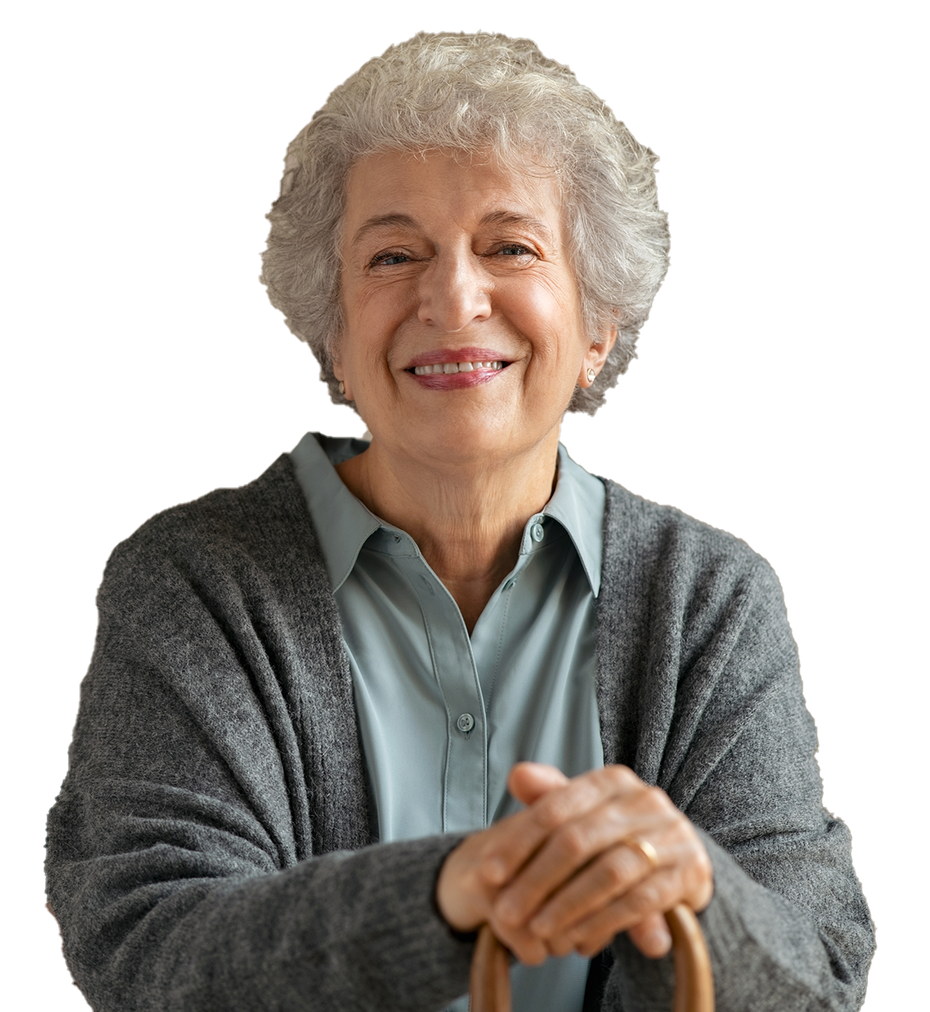 An elderly woman is smiling and holding a cane