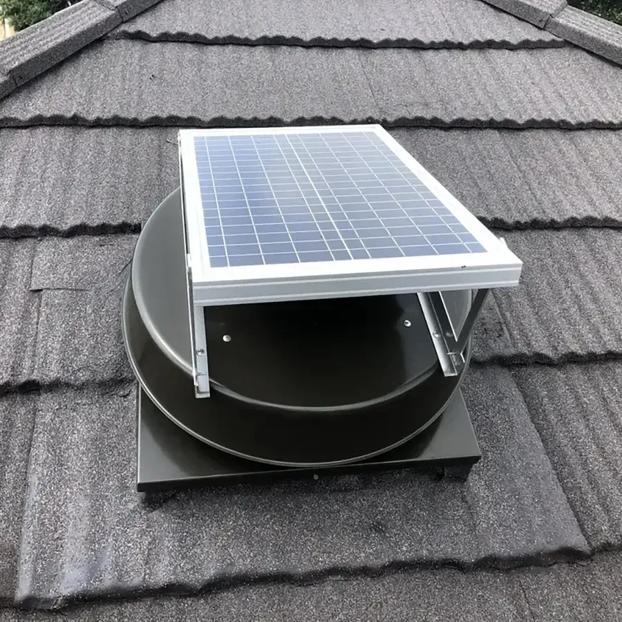 Solar-powered roof vent with a small panel mounted on a shingled roof.