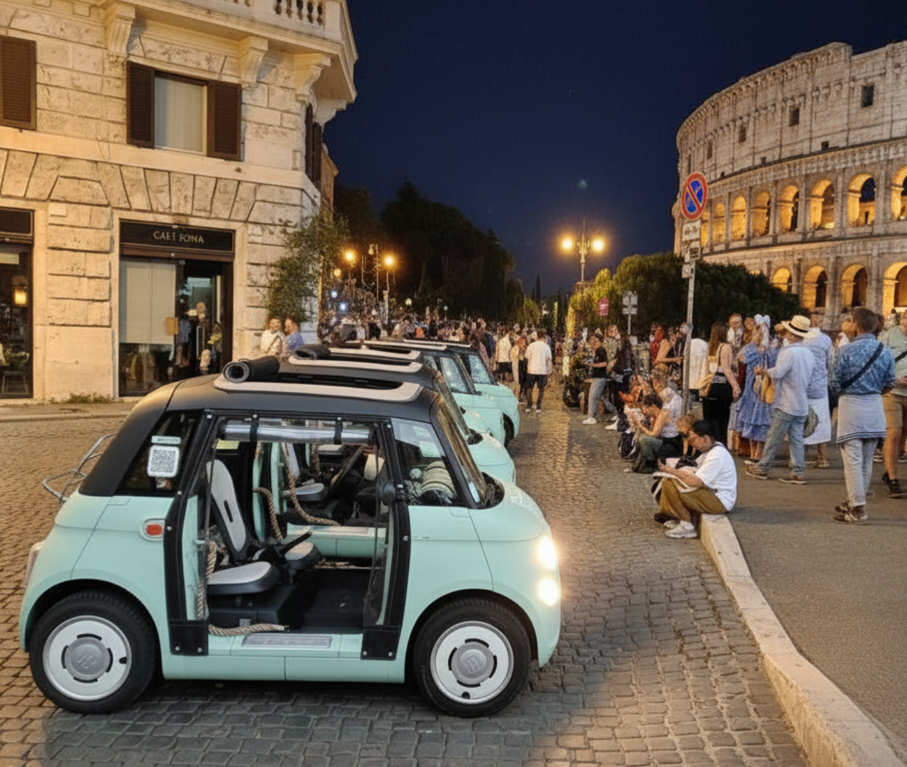 Mint green microcar on a cobblestone street at night, beside crowds and the Colosseum in Rome.
