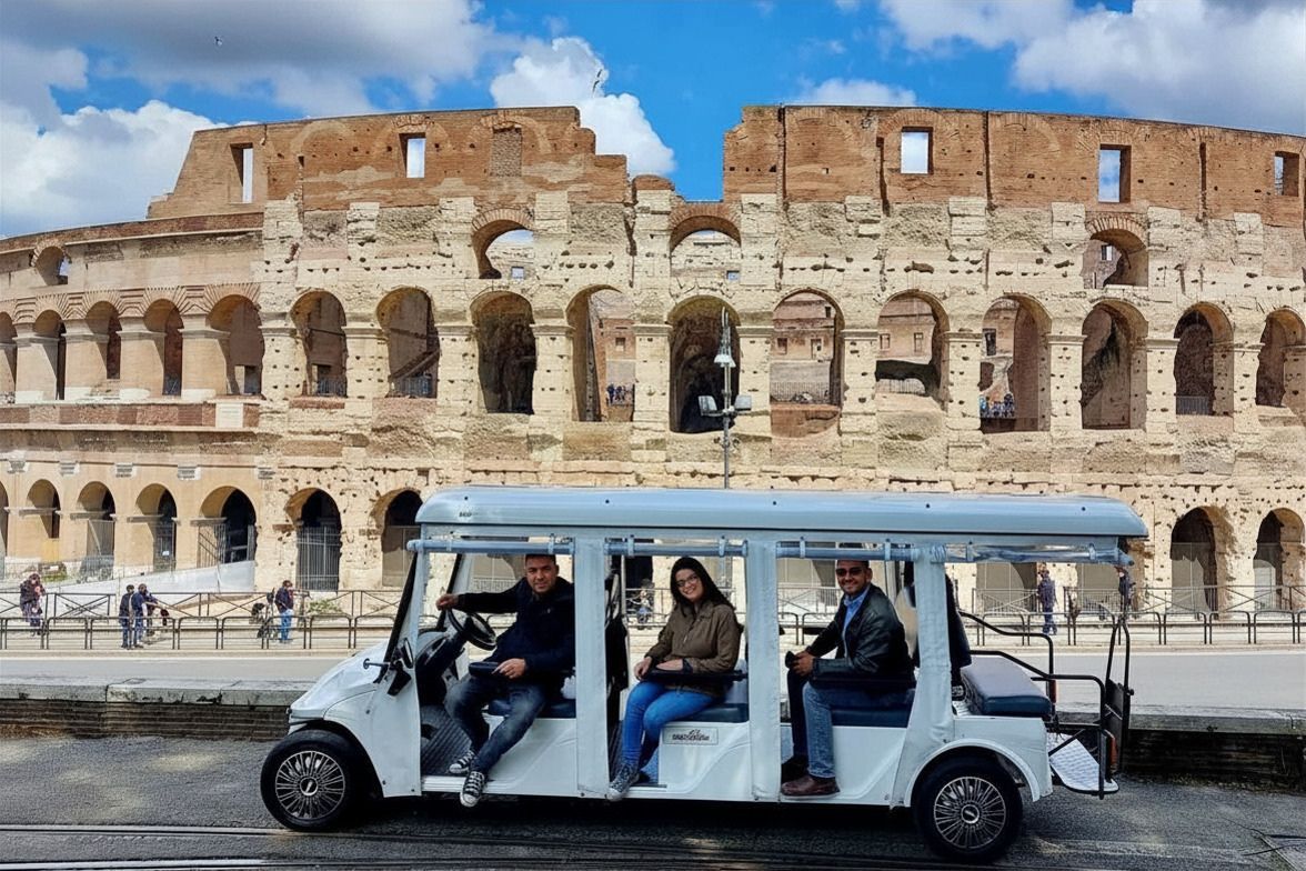 Tour cart with passengers in front of the Colosseum in Rome
