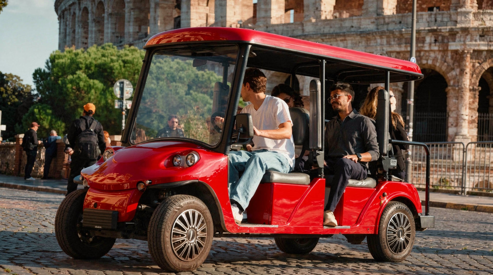 Red electric shuttle cart with passengers driving on a cobblestone street beside historic arches