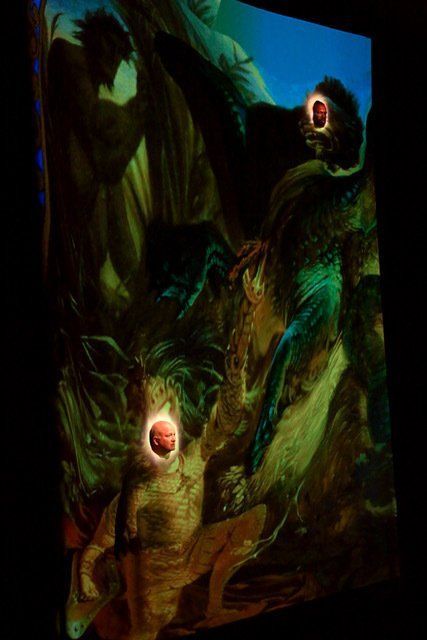 Gloomy surreal painting of two eerie figures with glowing mouths amid dark green foliage and shadows