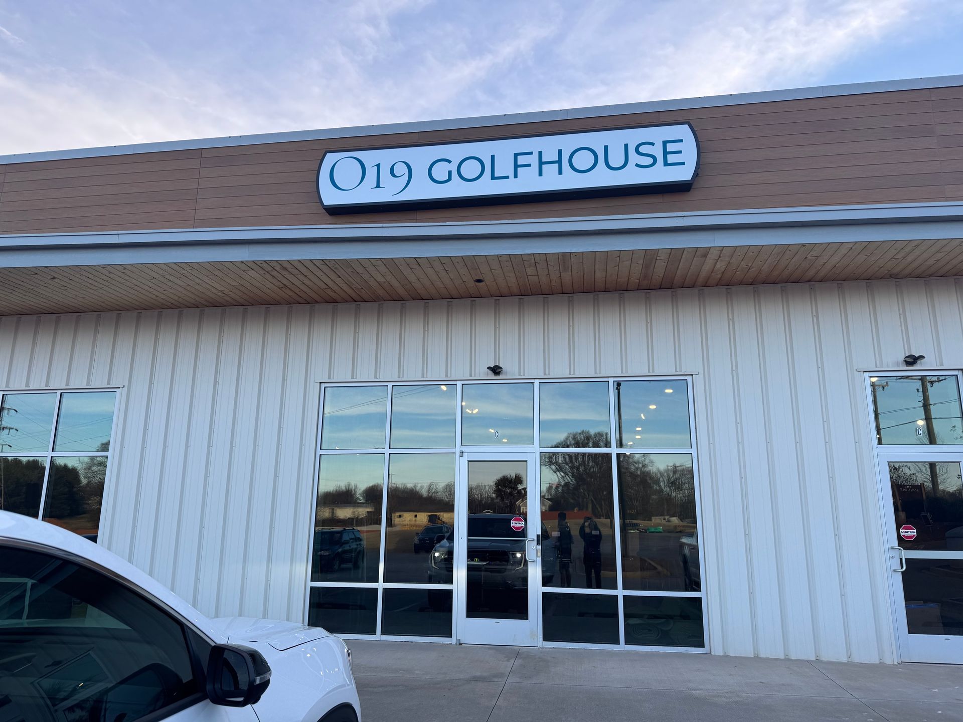 Golfhouse storefront with a blue sign above glass doors and windows.