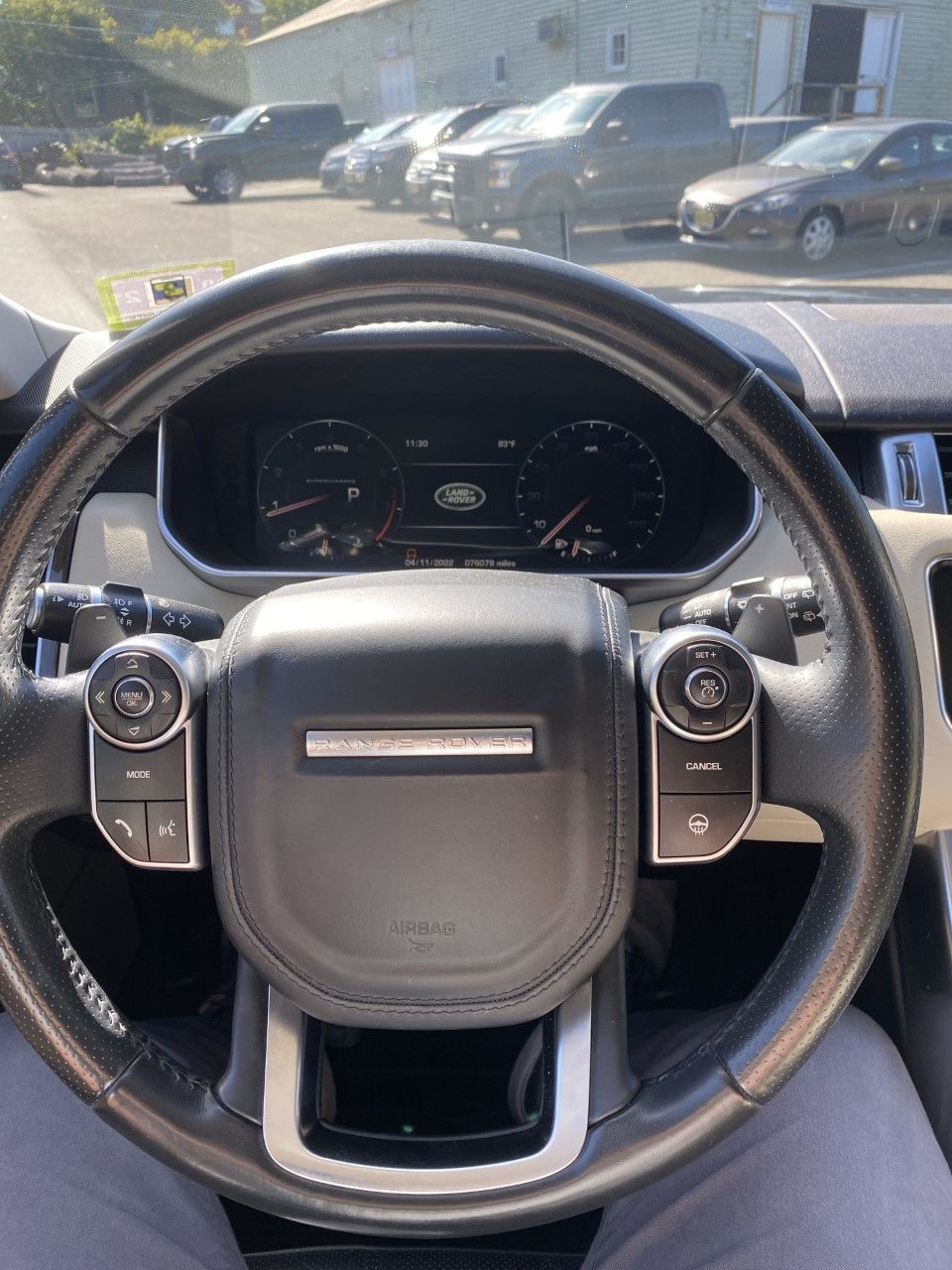 A person is sitting in the driver 's seat of a range rover sport. | InTown Auto Care