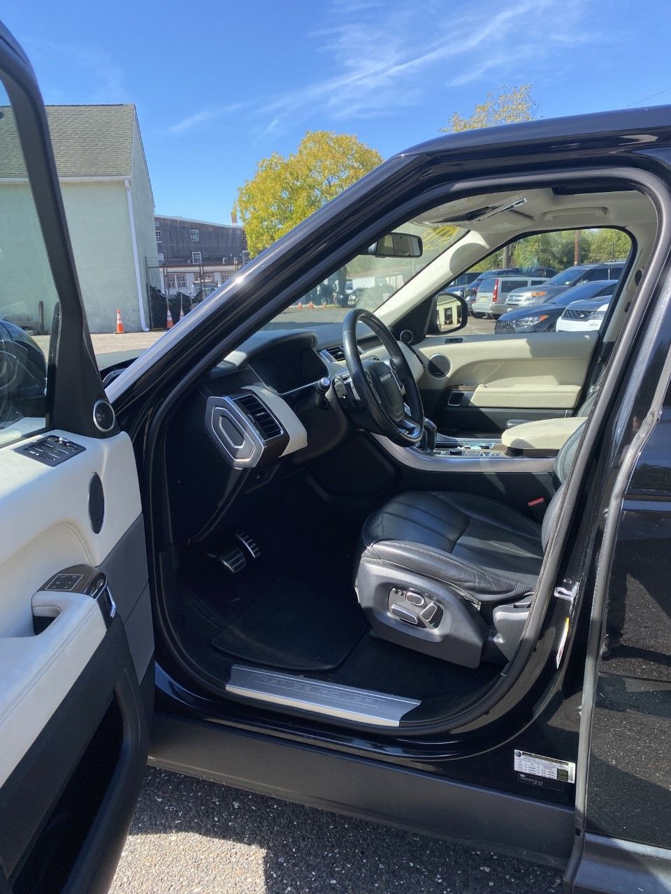 The inside of a black range rover sport with the door open. | InTown Auto Care