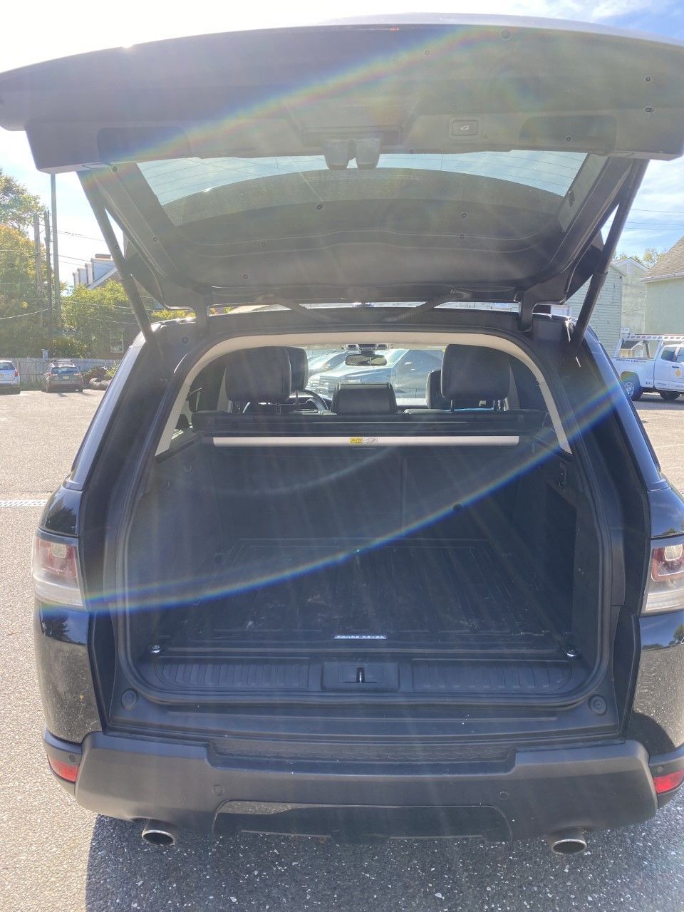 The back of a black suv with the trunk open is parked in a parking lot. | InTown Auto Care