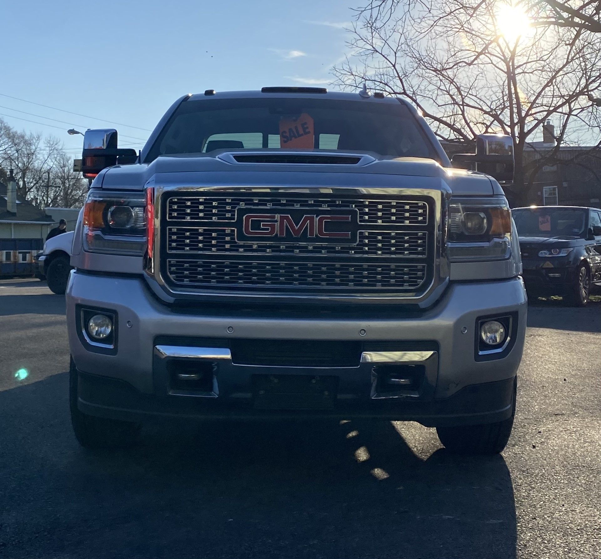 A silver gmc truck is parked in a parking lot | InTown Auto Care