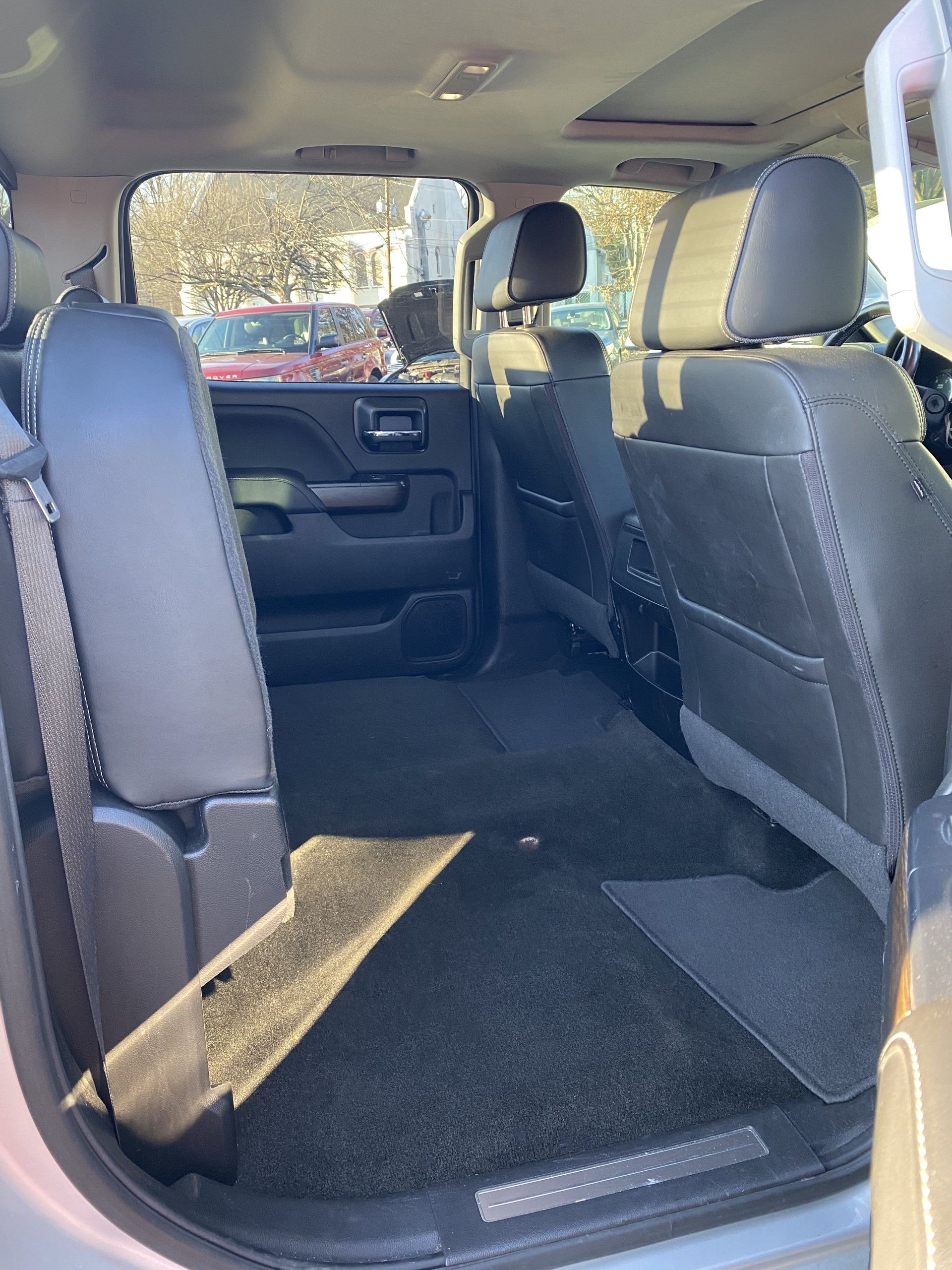 The back seat of a silver truck with black leather seats. | InTown Auto Care