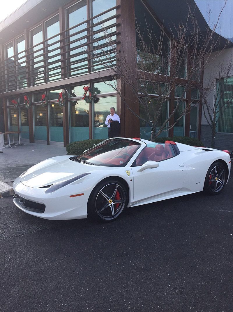 A White Ferrari is Parked Next to a Building - InTown Auto Care