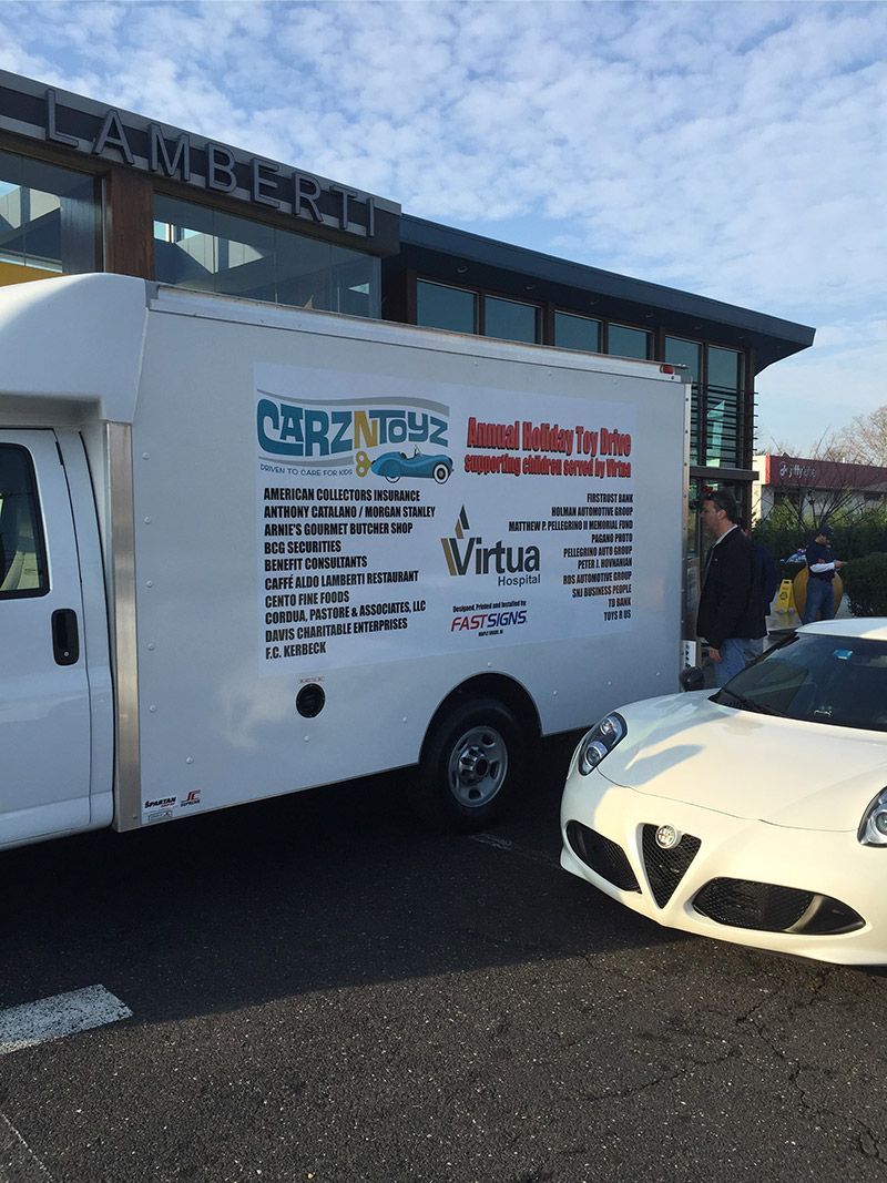 A white van is parked next to a white sports car | InTown Auto Care