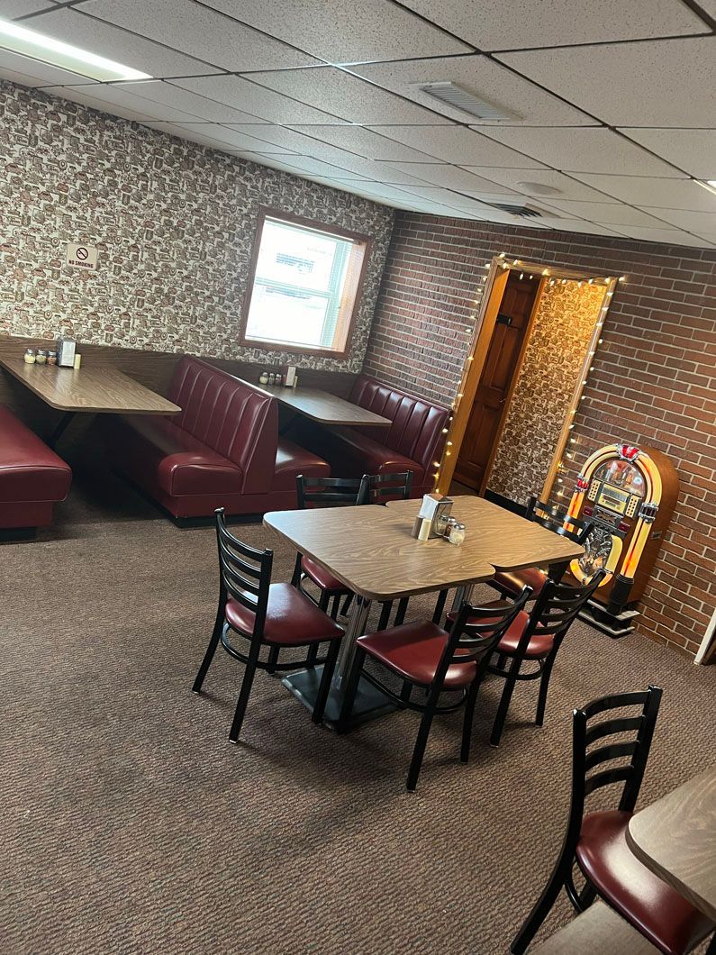 A diner with tables and chairs and a jukebox.