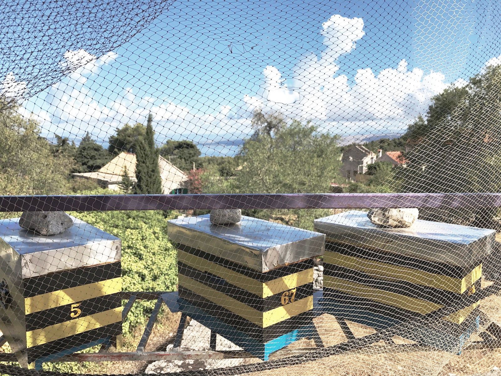 A bunch of beehives are sitting on top of each other on a balcony.