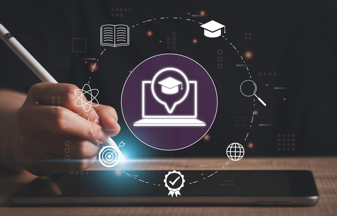Hand tapping tablet with glowing e-learning icon and digital education symbols on dark background