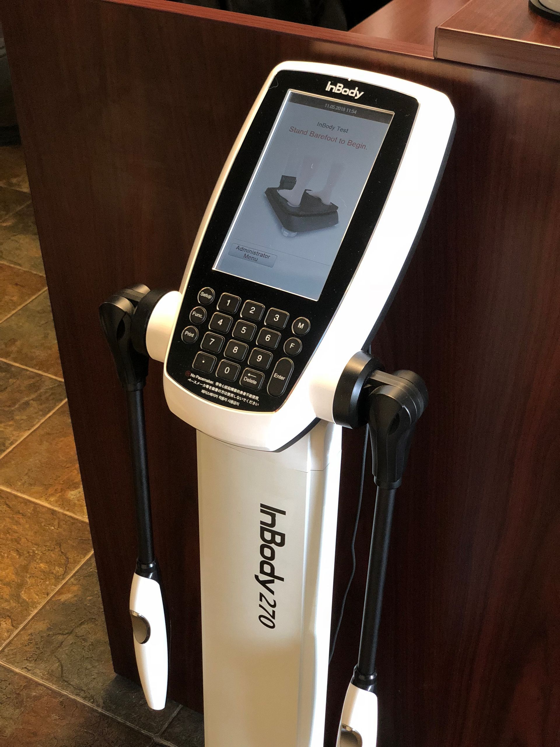 InBody 270 body composition analyzer at Team West Fitness, a gym in Westminster CA. White device with screen and handles; buttons below.
