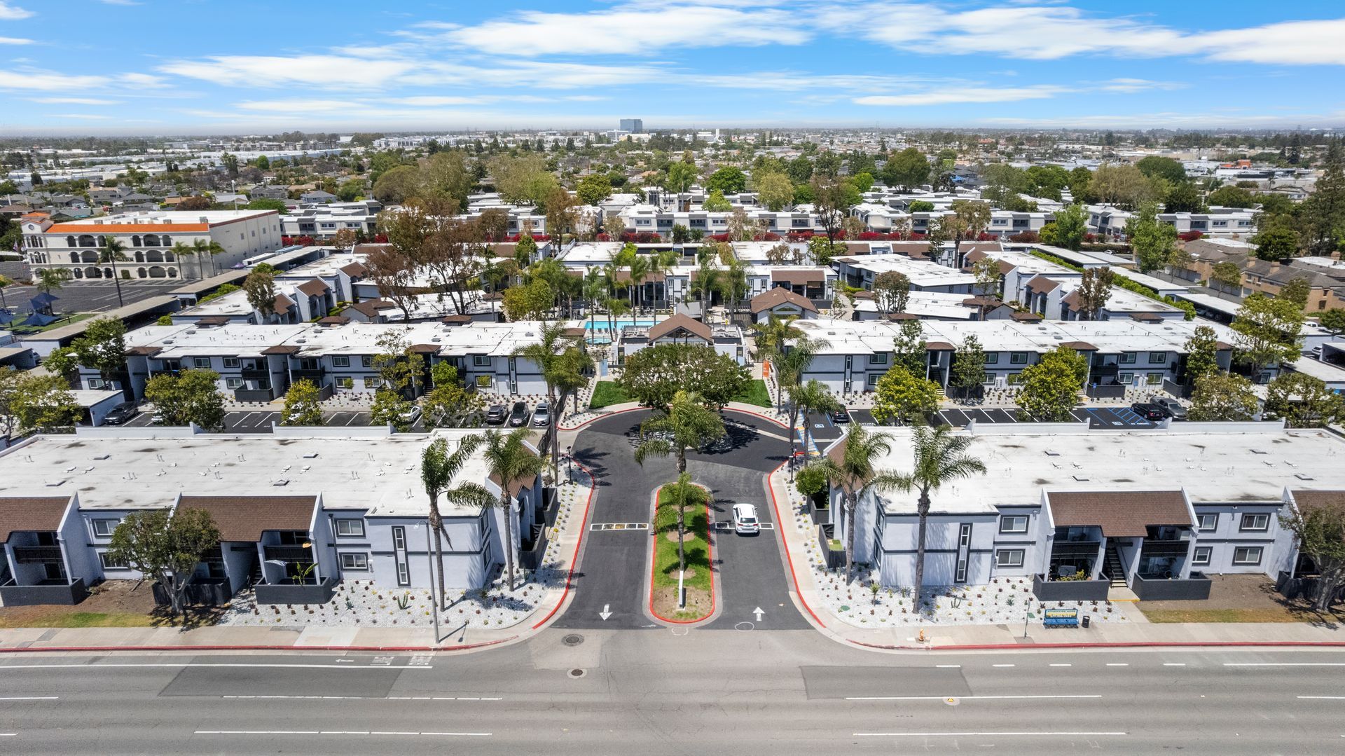 An aerial view of a residential area with lots of buildings and palm trees.