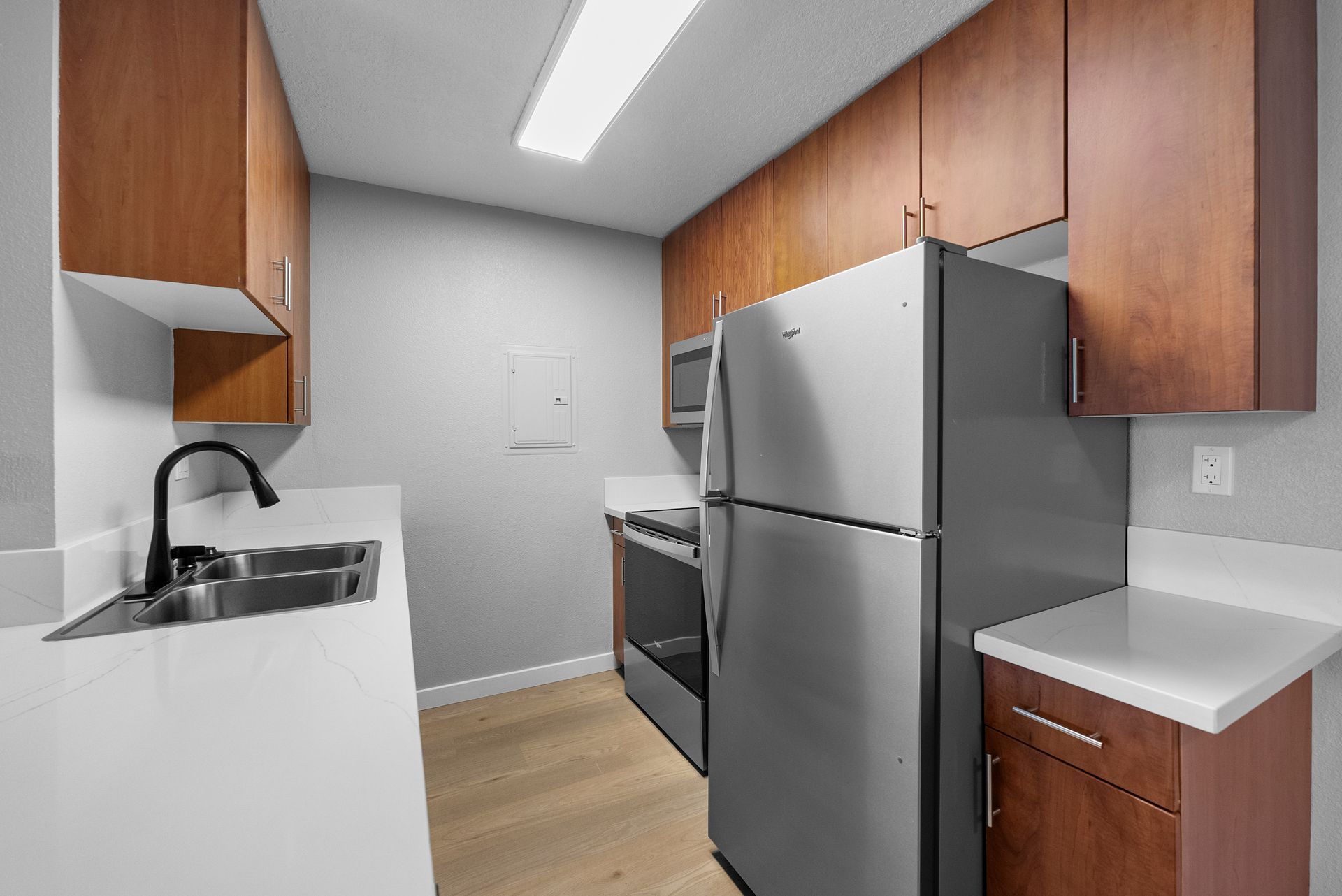A kitchen with stainless steel appliances and wooden cabinets