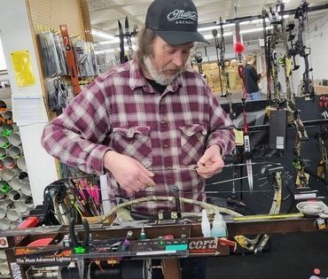 A man fixing a longbow.
